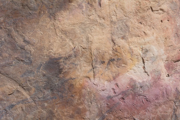 Textured surface of colorful rock