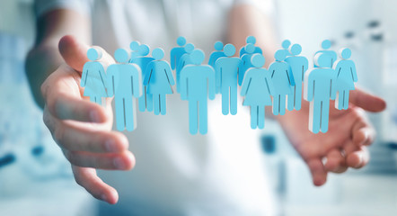 Businessman holding 3D rendering group of people in his hand
