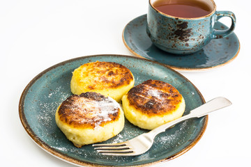 Curd cheese pancakes on the plate on white background