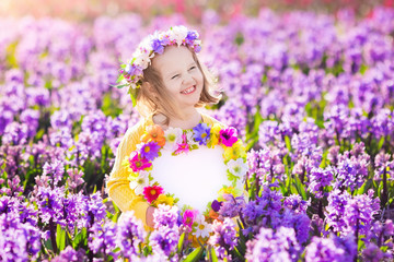 Fototapeta premium Little girl in hyacinth field