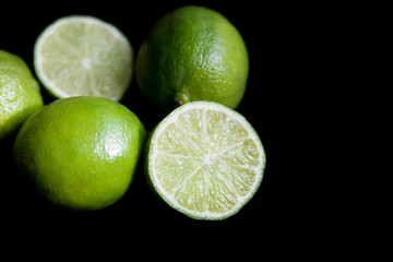 juicy limes on a black background