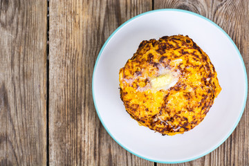 Pumpkin Pancake on plate on background of old wooden planks