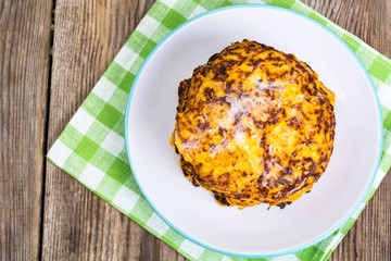Pumpkin Pancake on plate on background of old wooden planks