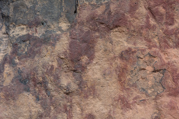 Textured surface of colorful rock