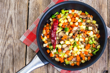Vegetables with mushrooms, cooked in frying pan