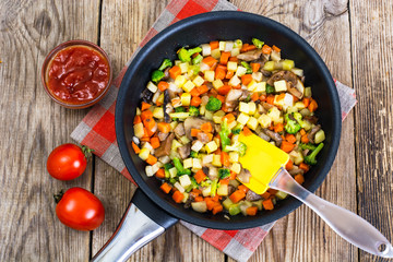 Vegetables with mushrooms, cooked in frying pan