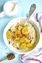 Oat porridge with caramelized banana and cinnamon .Top view.