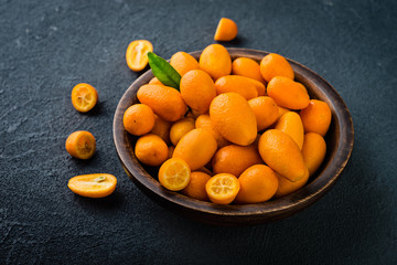 Citrus fruits,   kumquats on wooden bowl,  vitamin food concept