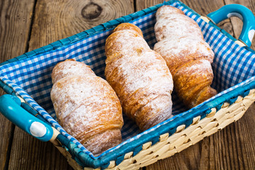Delicious crispy croissants in bread basket