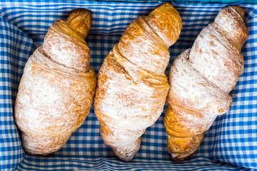 Delicious crispy croissants in bread basket