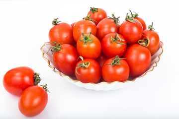 Fresh small tomatoes in white salad bowl