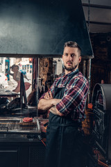 Portrait of stylish cook on a kitchen.