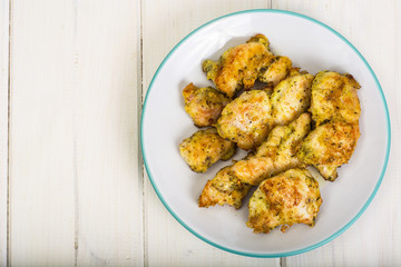 Pieces of fried chicken in breadcrumbs on plate
