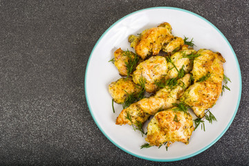 Pieces of fried chicken in breadcrumbs on plate