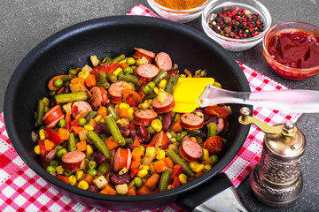 Mexican mix of vegetables with sausages in pan