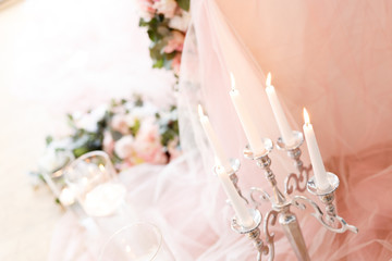 Candles near the wedding table in ivory colors