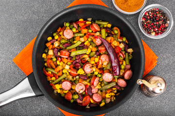 Mexican mix of vegetables with sausages in pan