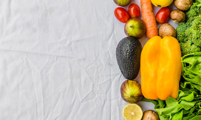 Flat lay photo of fresh fruit and vegetables, grains, and nuts on a white background. Concept of cooking and eating healthy food, fitness, vegetarian and vegan, and lifestyle.