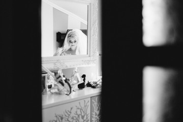 young bride portrait with perfume is getting ready at home in the morning, wedding day