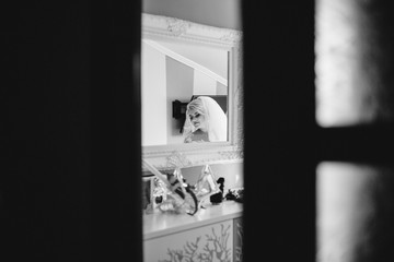 young bride portrait with perfume is getting ready at home in the morning, wedding day