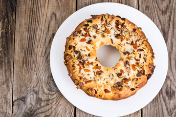 Cake with nuts and dried apricots on wooden background