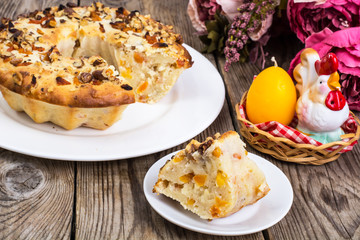Cake with nuts and dried apricots on wooden background