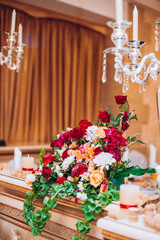 Wedding flower composition for guests and newlyweds tables. Wedding arch and flowers decor.