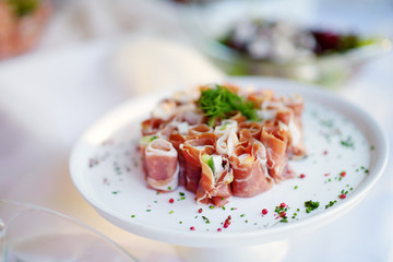 Delicious ham rolls with vegetables served on a party or wedding reception