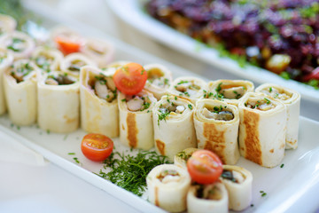 Delicious pork rolls with vegetables served on a party or wedding reception