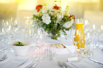 Beautiful table setting with crockery and flowers for a party, wedding reception or other festive event