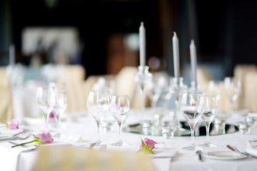 Beautiful table setting with crockery and flowers for a party, wedding reception or other festive event