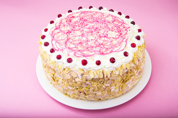 Sponge cake with almonds, whipped cream and berries