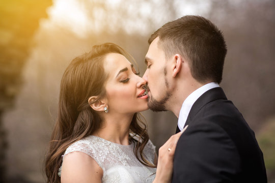 Bride and groom kissing at wedding ceremony, happy couple in love, wedding kiss