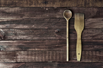 wooden kitchen spatula and a spoon on a brown surface