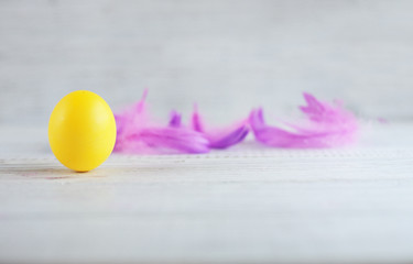 Yellow eggs and feathers. The concept of a happy Easter.