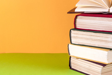 Open book, hardback bookson bright colorful background.