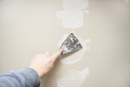 Drywall repair plastering closeup