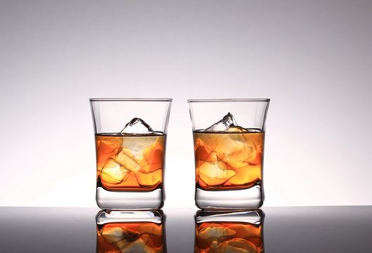 Glasses with whiskey and ice