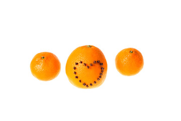 Fresh juicy bright tangerine and orange decorated with a heart of carnation on a white background.