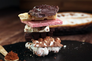 Melting chocolate and diffrent bars - stack and chips with chocolate swirl/ powder and cocoa pod with melted chocolate