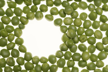 Fresh raw green peas on white background