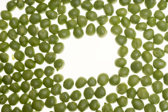 Fresh raw green peas on white background