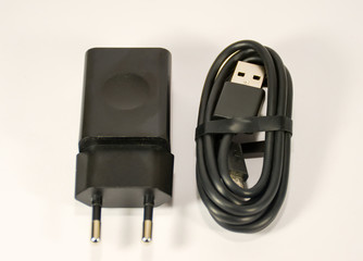 The power supply and USB cable for mobile phone.