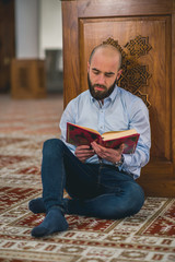 Muslim scholar studying holy and revered book Koran