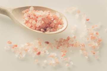 Himalayan salt on a spoon and white table