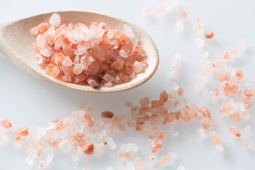 Himalayan salt on a spoon and white table