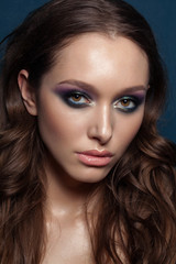 Beautiful young brunet model with perfect makeup and long hair. Gorgeous Woman Face. Bright makeup.