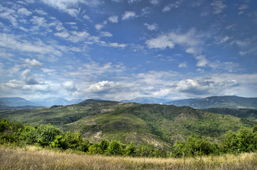 Beautiful summer landscape in mountains, green meadows and the dark blue sky with clouds . Big Caucasus. Azerbaijan