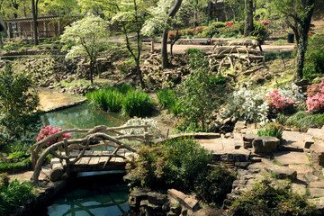 Fototapeta na wymiar A bridge over a stream, pond, flowering Park Old Mill, the city of Little Rock, Arkansas, USA