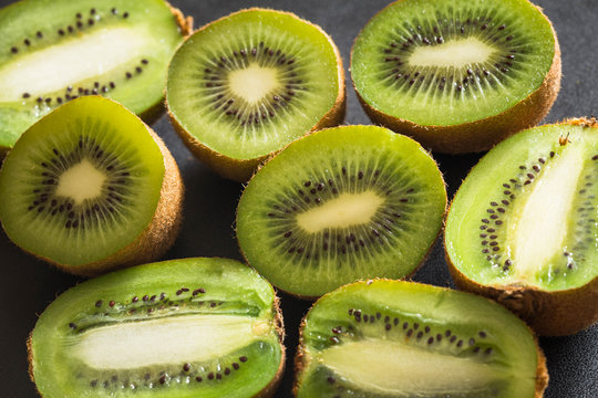 Kiwi fruits on a dark stone table